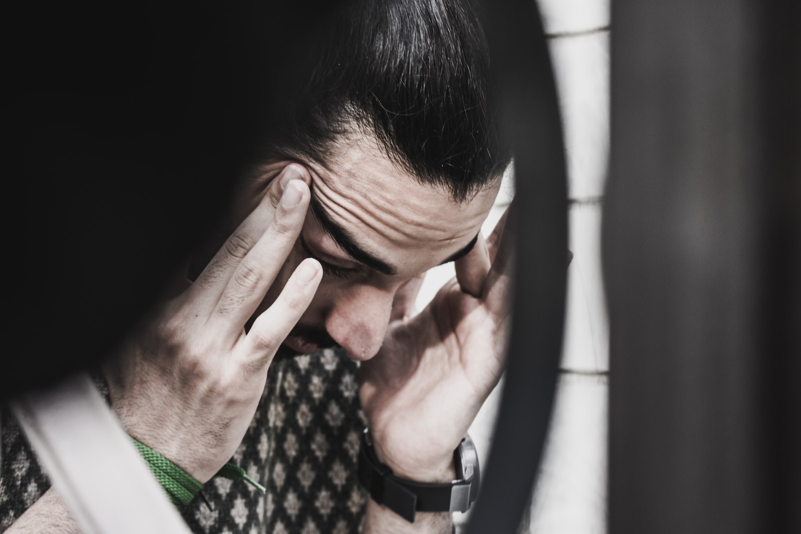 Breaking free: how to get revenge on a narcissist 21 Man holding his temples and looking down-how to get revenge on a narcissist